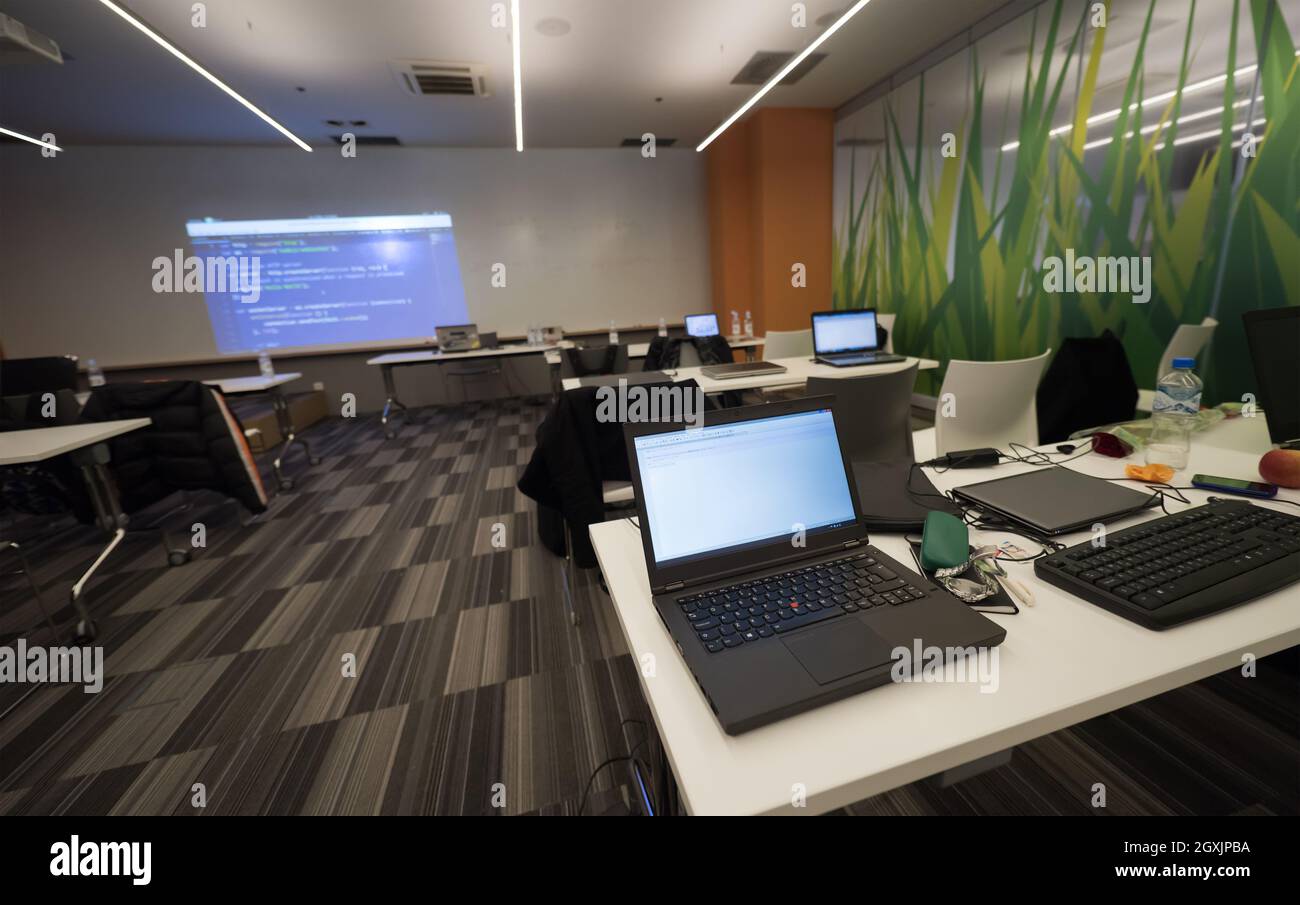 empty it classroom with program code on projector screen and modern