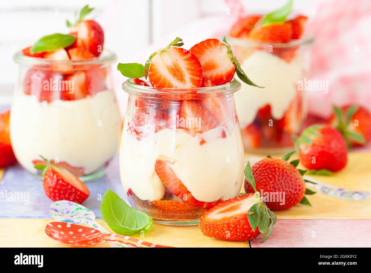 Cream dessert with fresh stawberries and basil Stock Photo