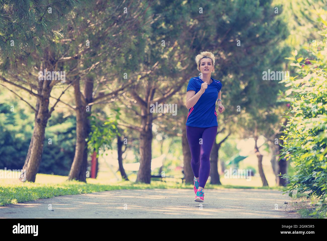 Young Sporty Female Runner Training For Marathon Running At Beautiful