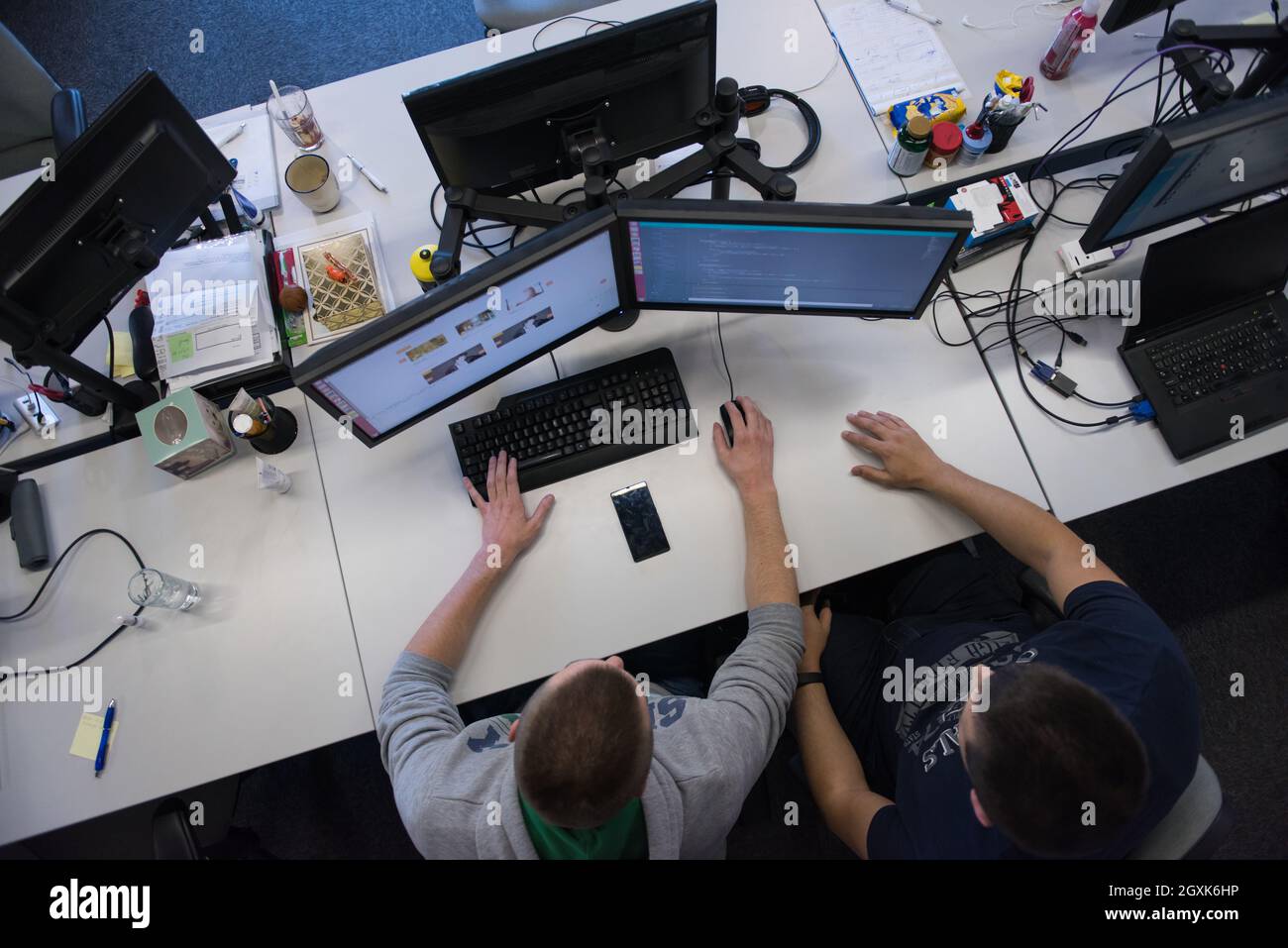top view of software developers writing programming code on computer Stock Photo