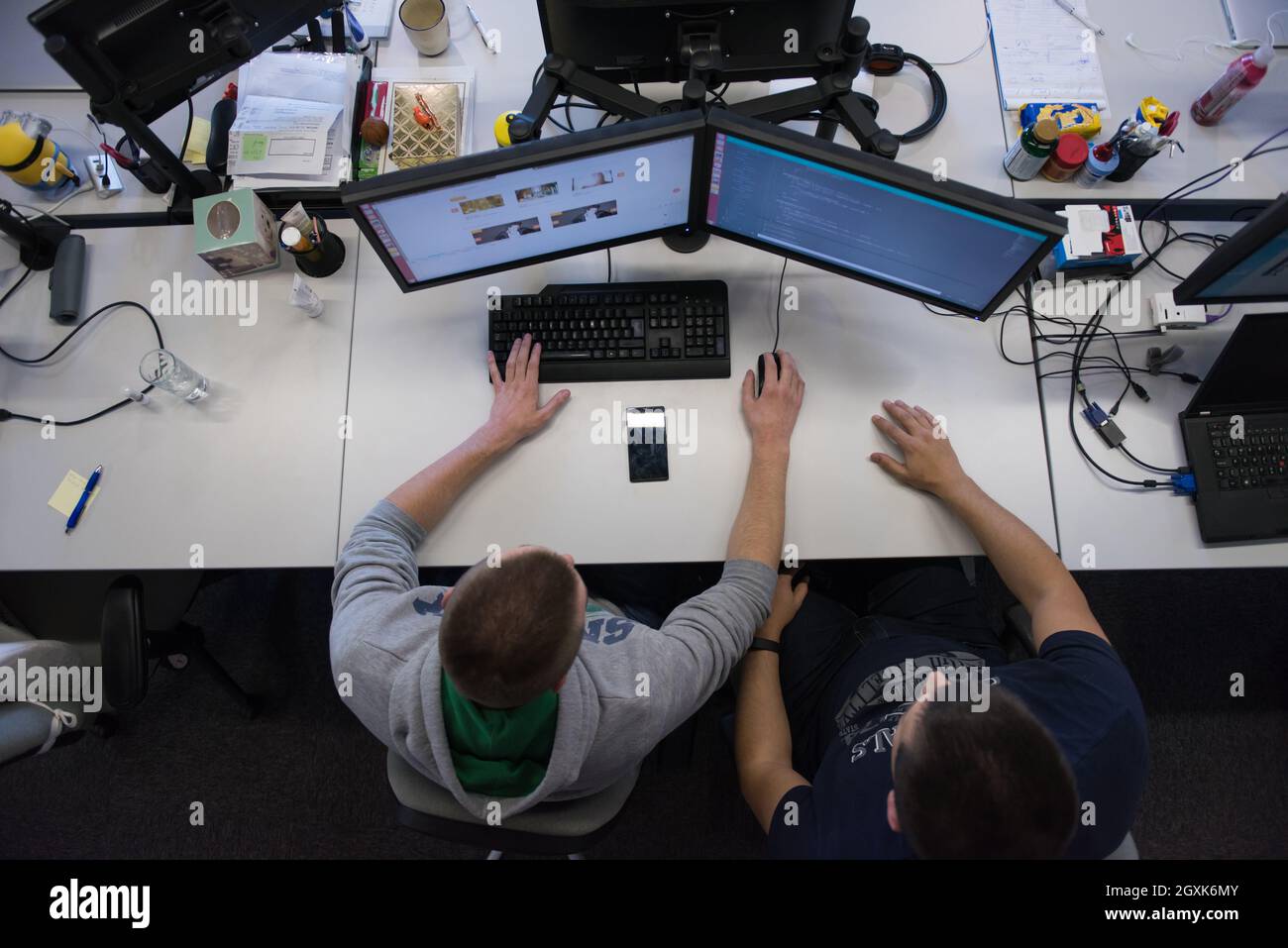 top view of software developers writing programming code on computer Stock Photo