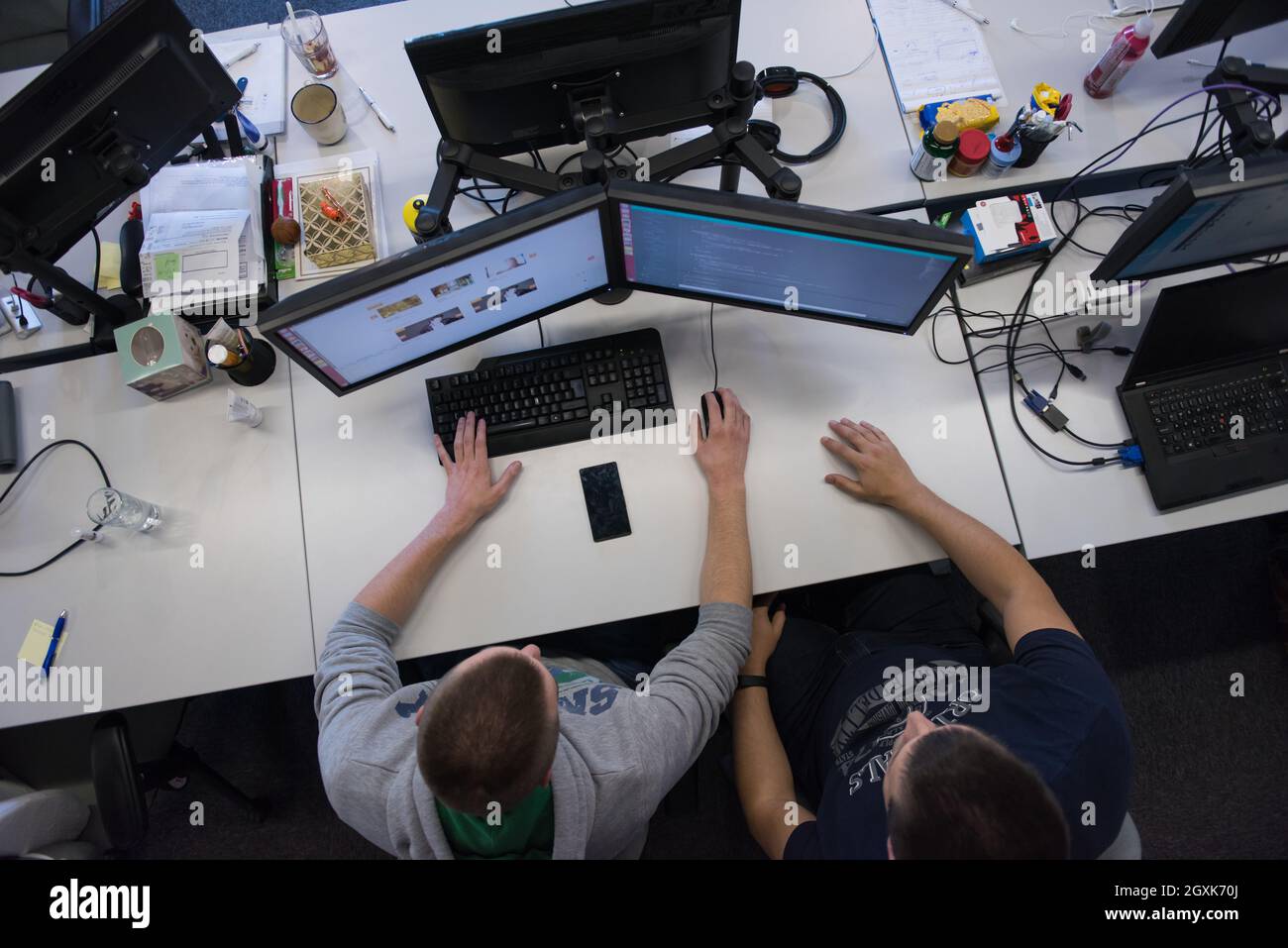 top view of software developers writing programming code on computer Stock Photo