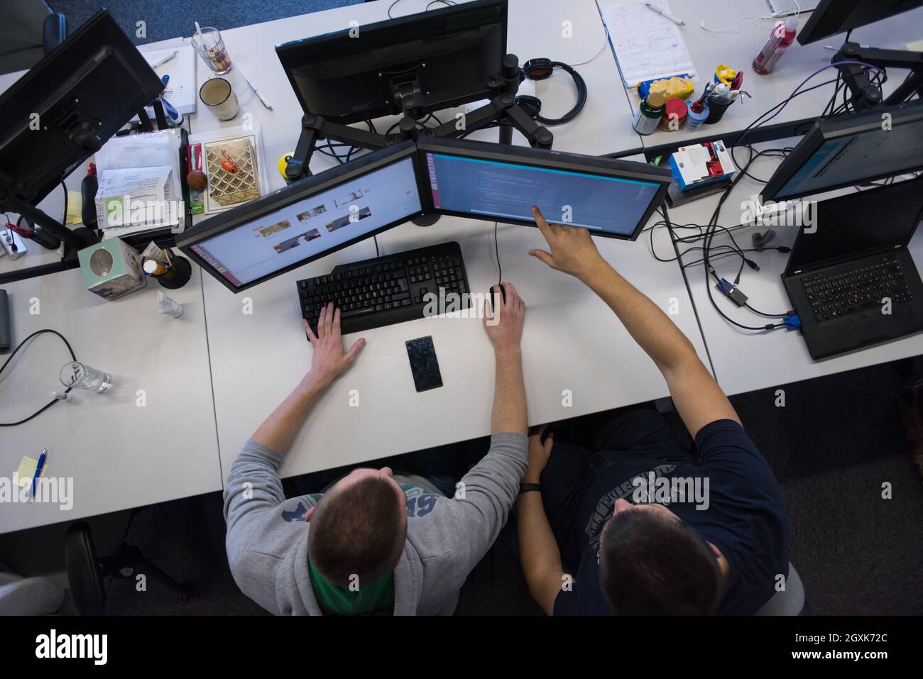 top view of software developers writing programming code on computer Stock Photo