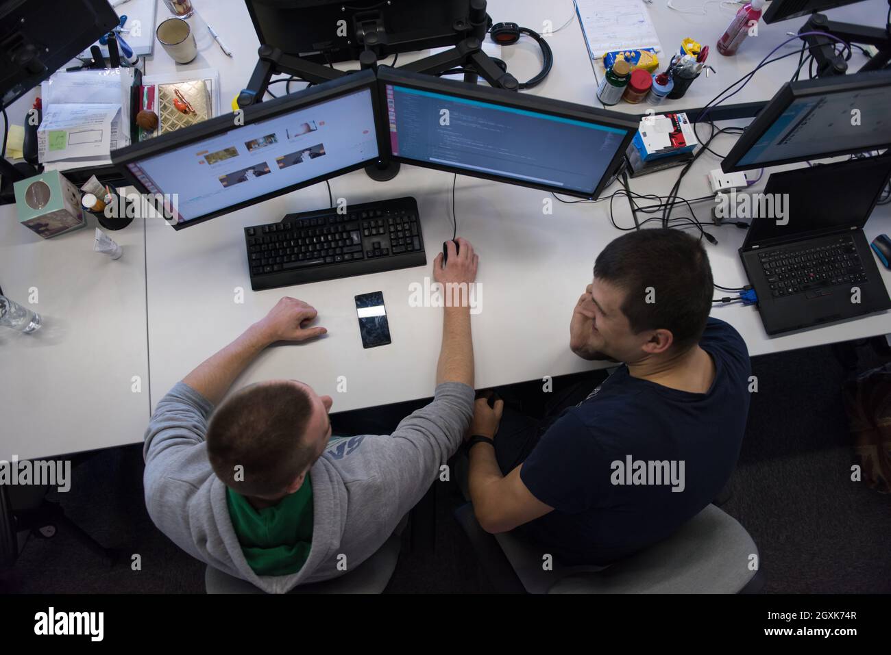 top view of software developers writing programming code on computer Stock Photo