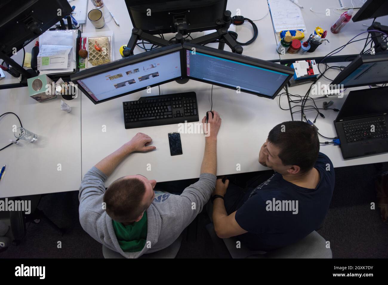 top view of software developers writing programming code on computer Stock Photo