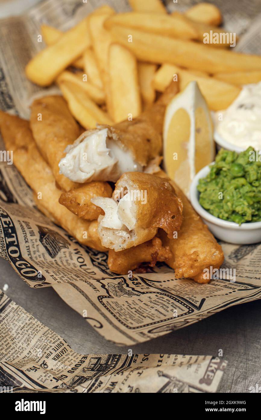 British Traditional crispy Fish and chips with mashed peas, tartar