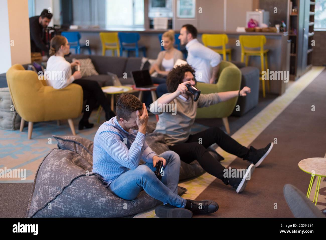 Work hard play hard. Workers Playing computer games in creative startup  Office Stock Photo - Alamy