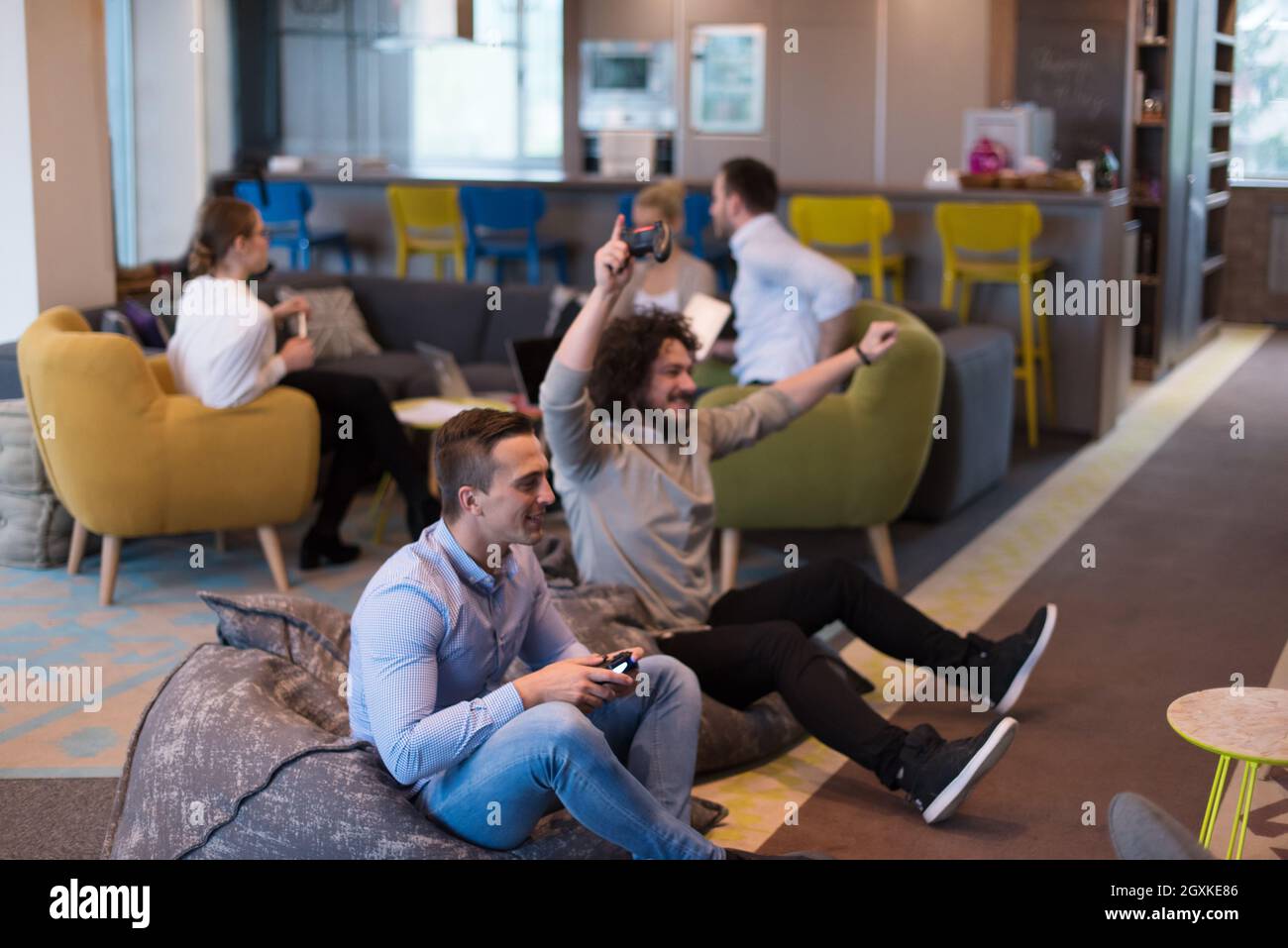 Work hard play hard. Workers Playing computer games in creative startup ...