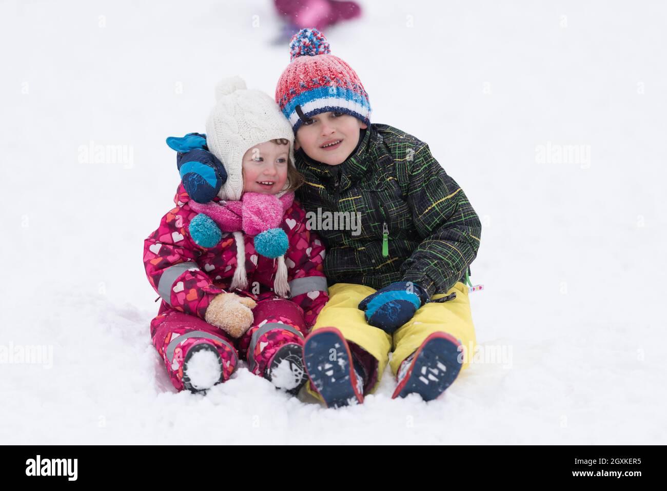 group of kids having fun and play together in fresh snow on winter ...