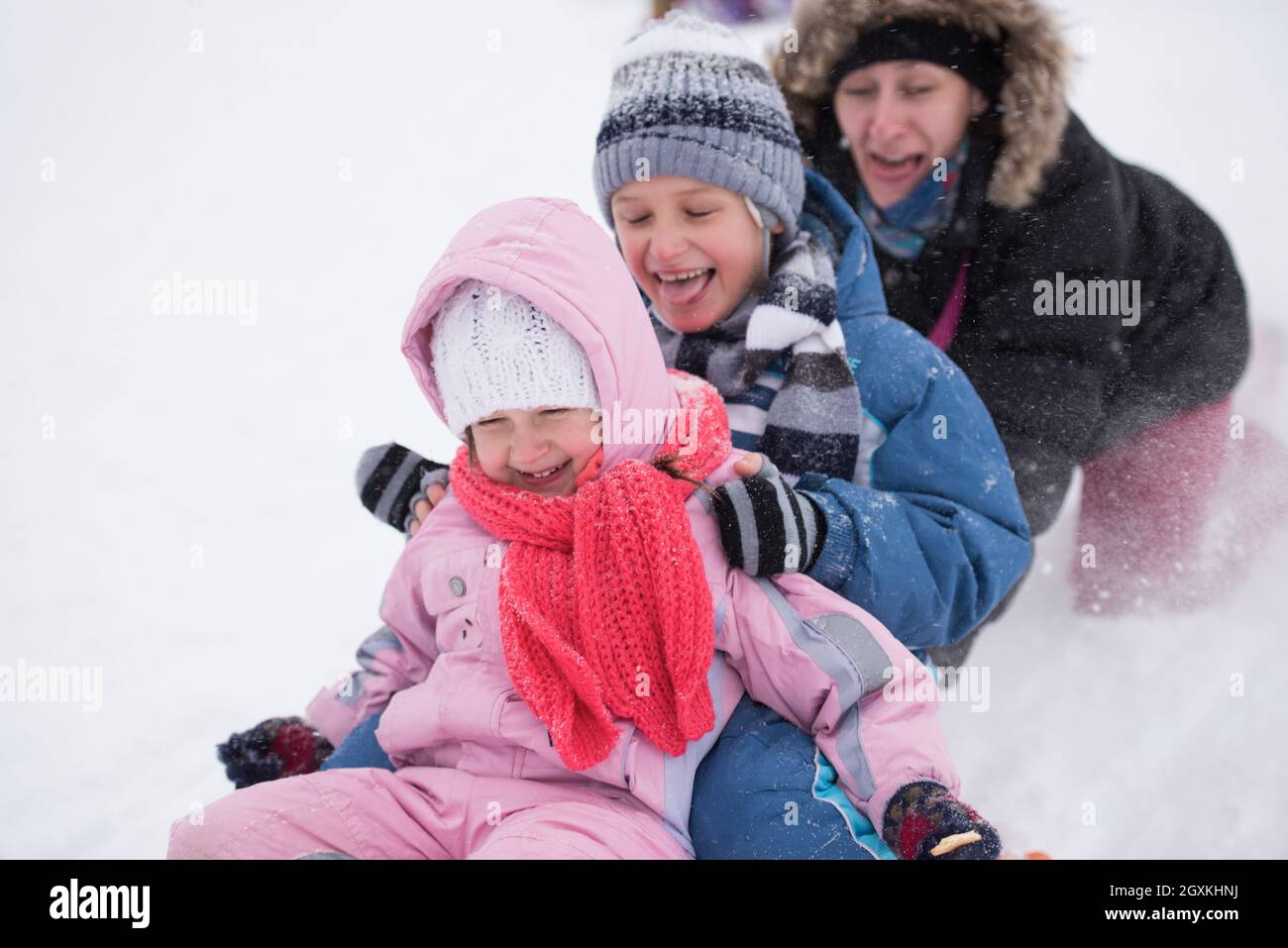group of children having fun and play together in fresh snow on winter ...