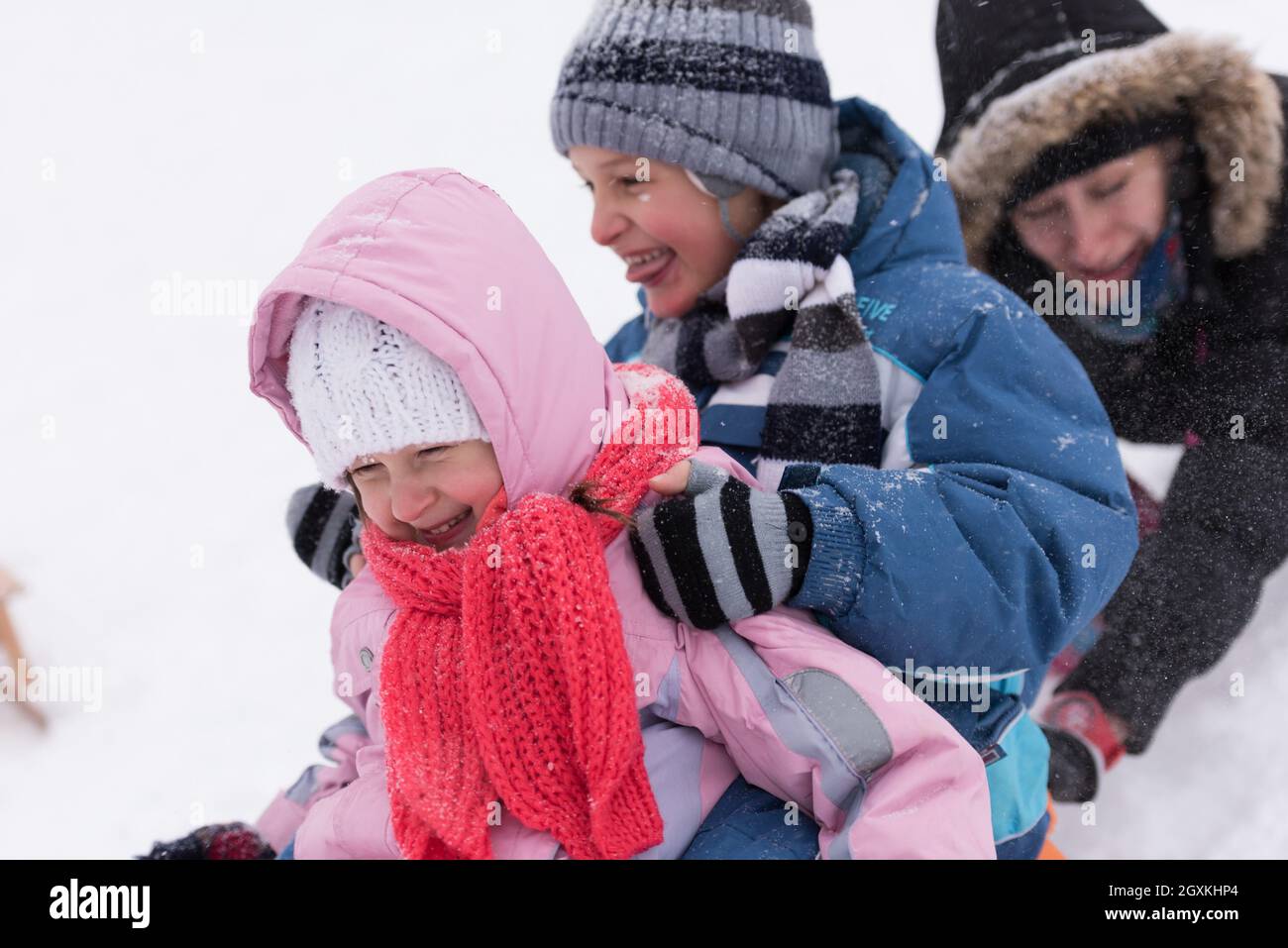 group of kids having fun and play together in fresh snow on winter ...