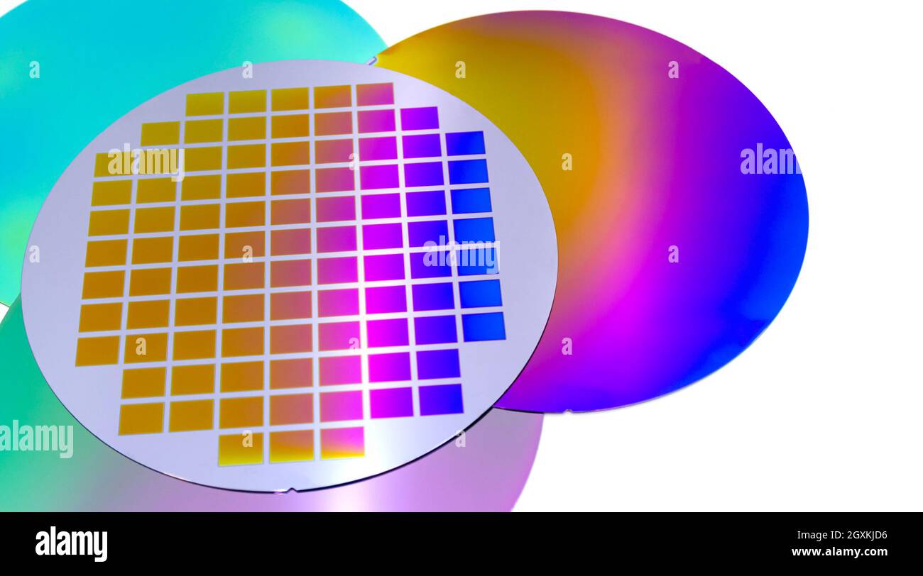 Several silicon wafers with printed circuit and different color. Banner format. Stock Photo