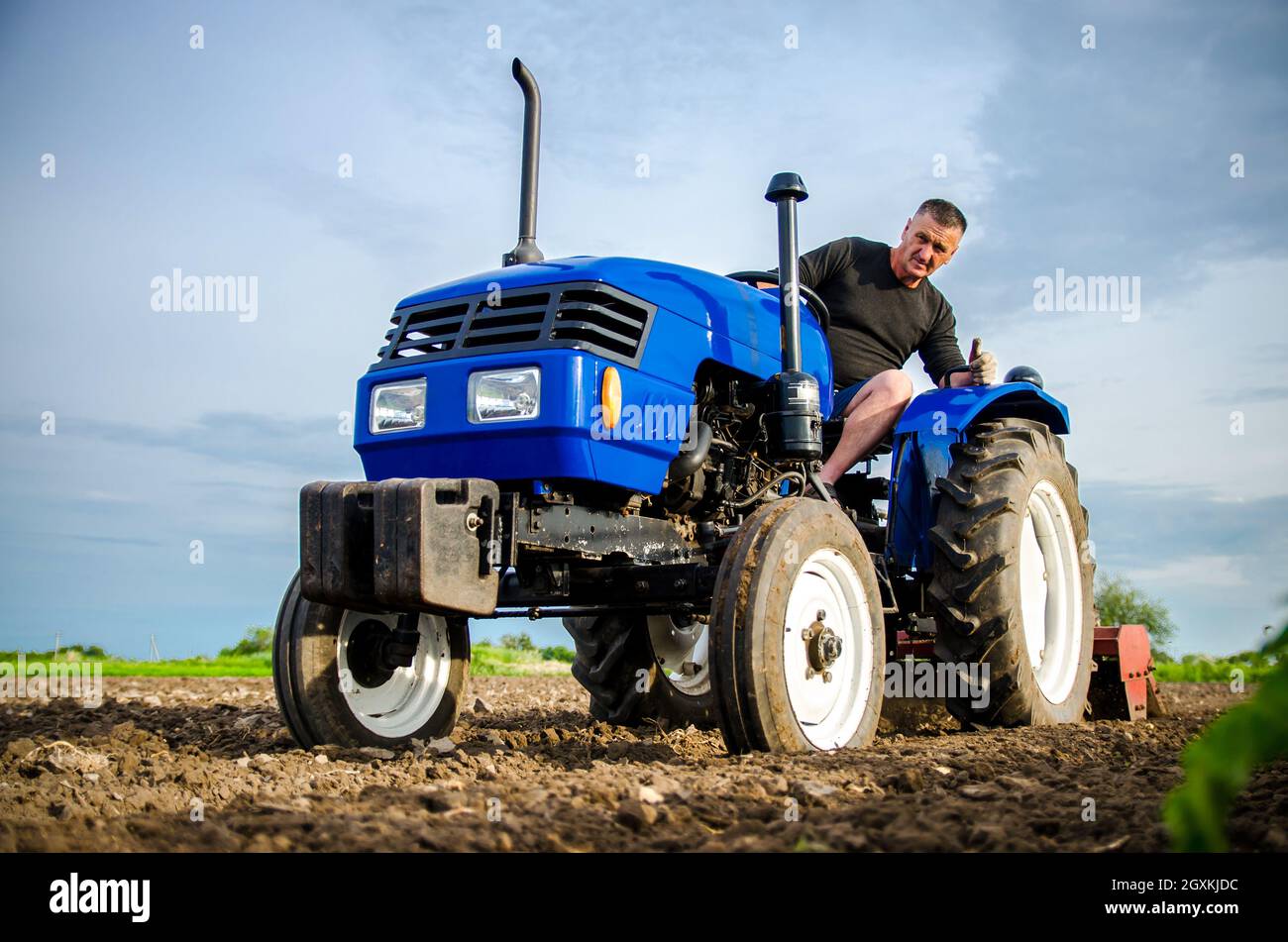 A farmer on a tractor cleans the field after harvest. Preparation of