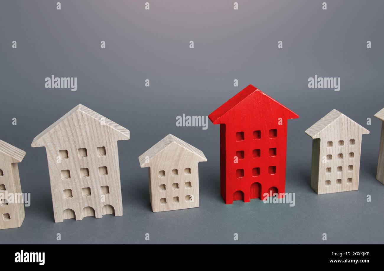 Red house among other buildings. Disconnection from utilities and communications, debts, emergency. Unsuitable for habitation, illegal construction. H Stock Photo