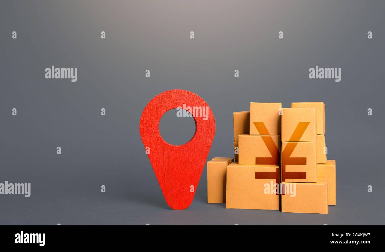 Cardboard boxes with chinese yuan or japanese yen and red pin location ...