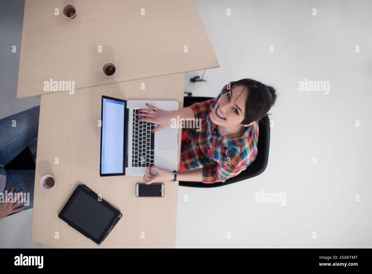 top view of young business woman working on laptop computer in modern ...
