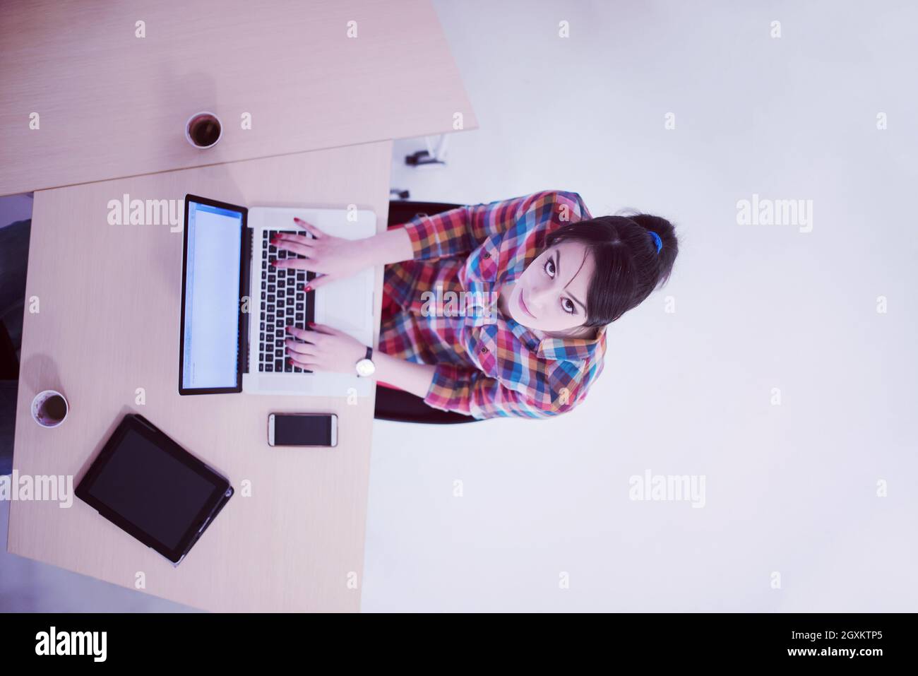 top view of young business woman working on laptop computer in modern ...