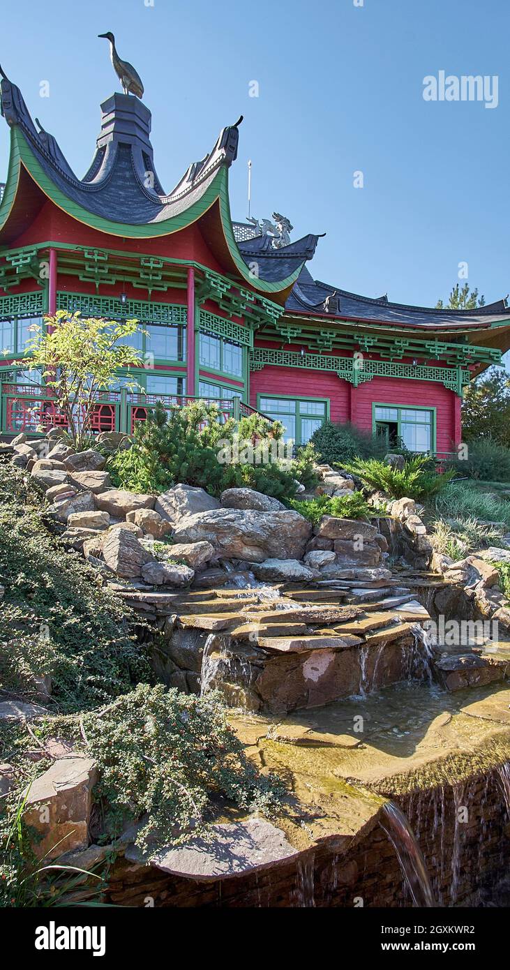 Pagoda-style modern house and waterfall in garden Stock Photo
