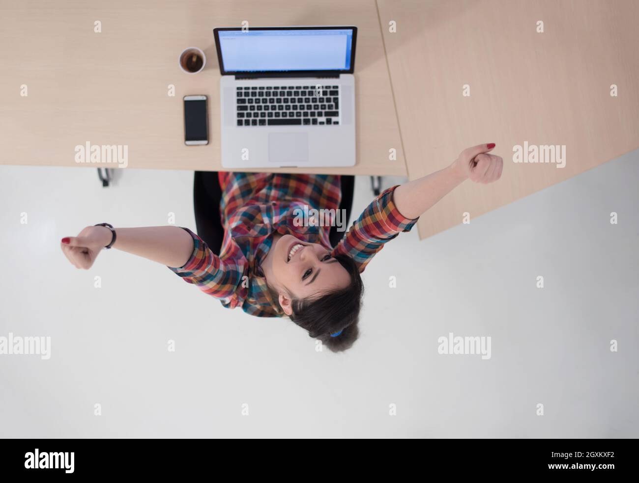 top view of young business woman working on laptop computer in modern ...
