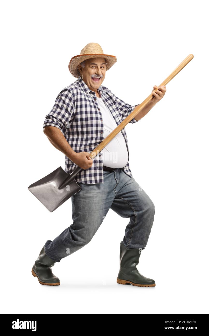 Full length portrait of a happy mature farmer playing guitar on a ...