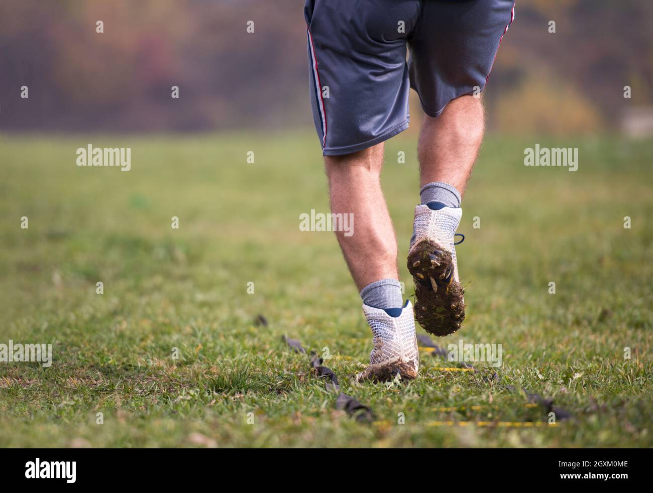 closeup of young american football player exercises on ladder drills at field Stock Photo