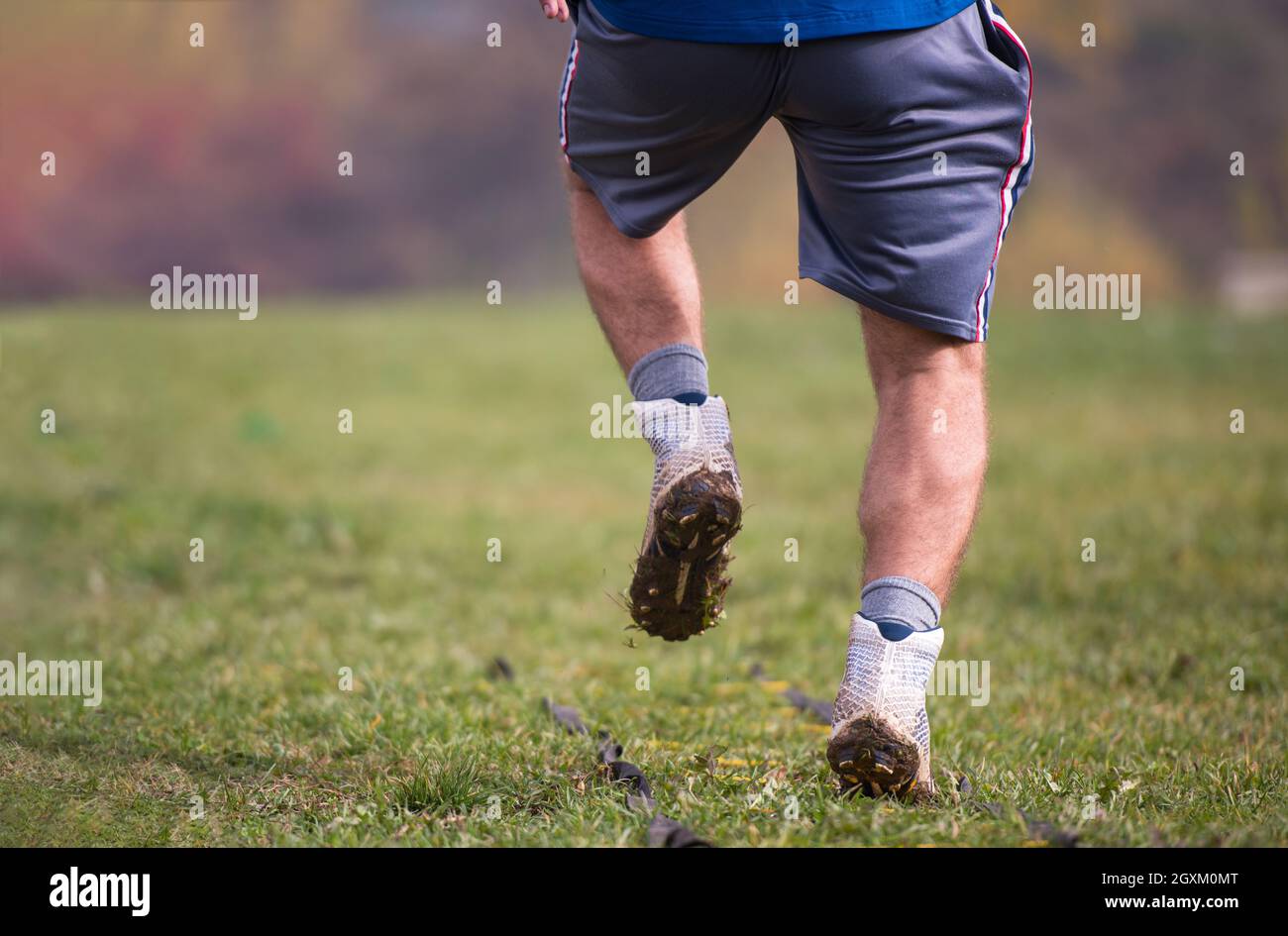 closeup of young american football player exercises on ladder drills at field Stock Photo