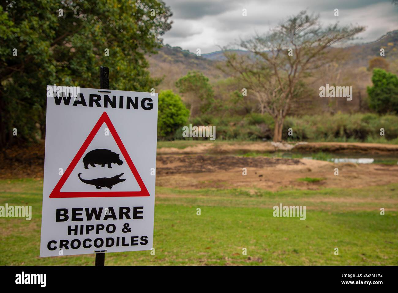 Warning sign indicating that there are hippopotamus and crocodile danger in the area Stock Photo
