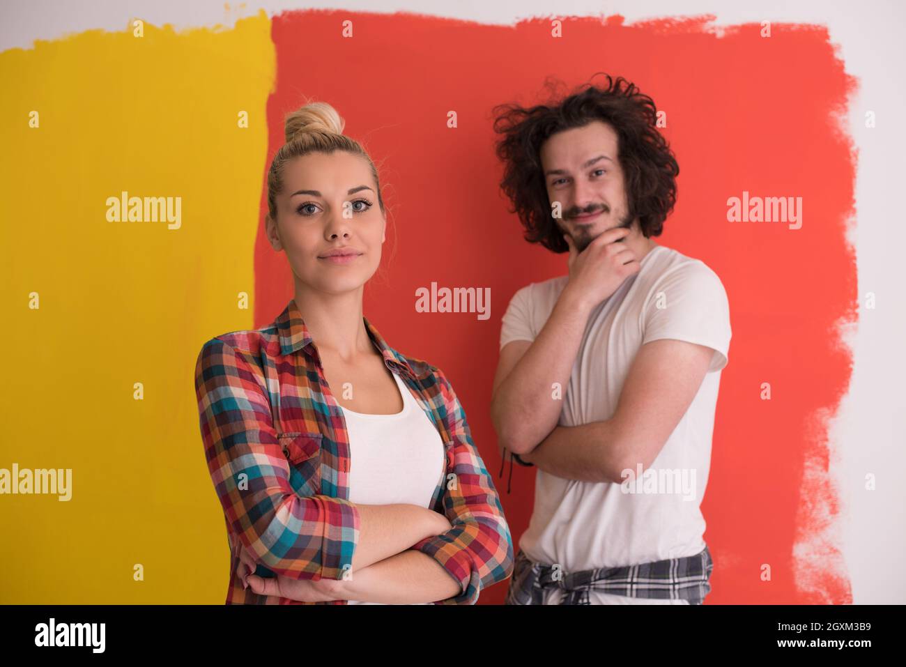 Portrait of a happy young smiling couple in love over color background ...