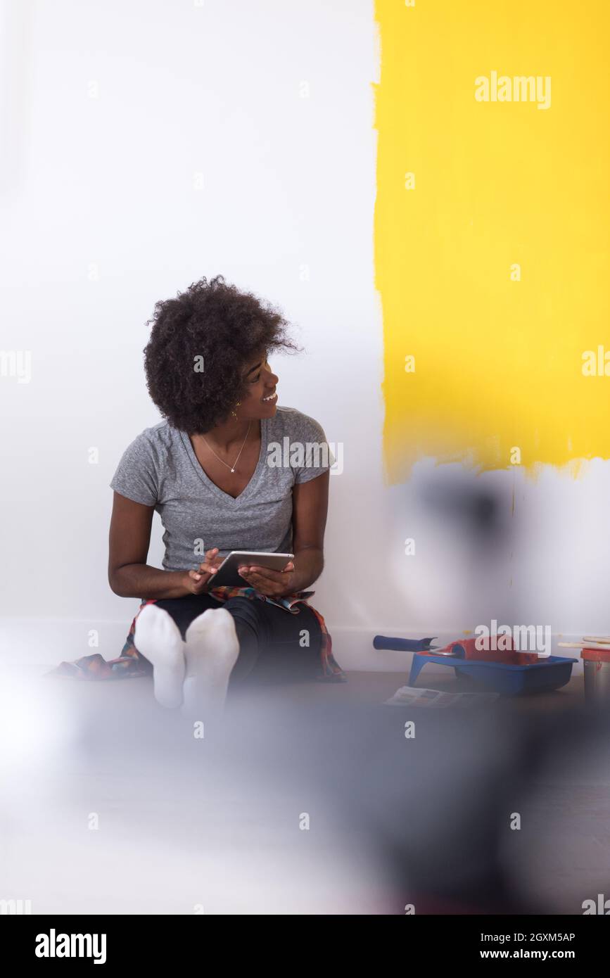 Portrait of a beautiful african american female painter sitting on ...