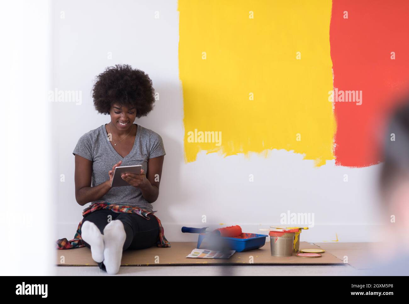 Portrait of a beautiful african american female painter sitting on ...