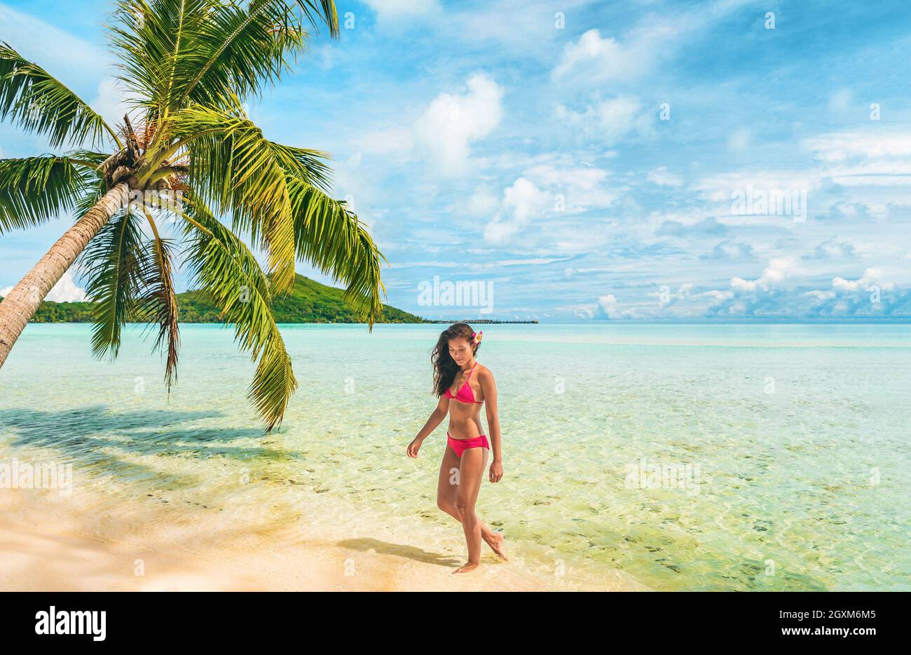 Luxury beach Tahiti Bora Bora bikini woman swimming in paradise getaway  vacation. Beautiful Asian swimsuit model relaxing walking in turquoise  ocean Stock Photo - Alamy