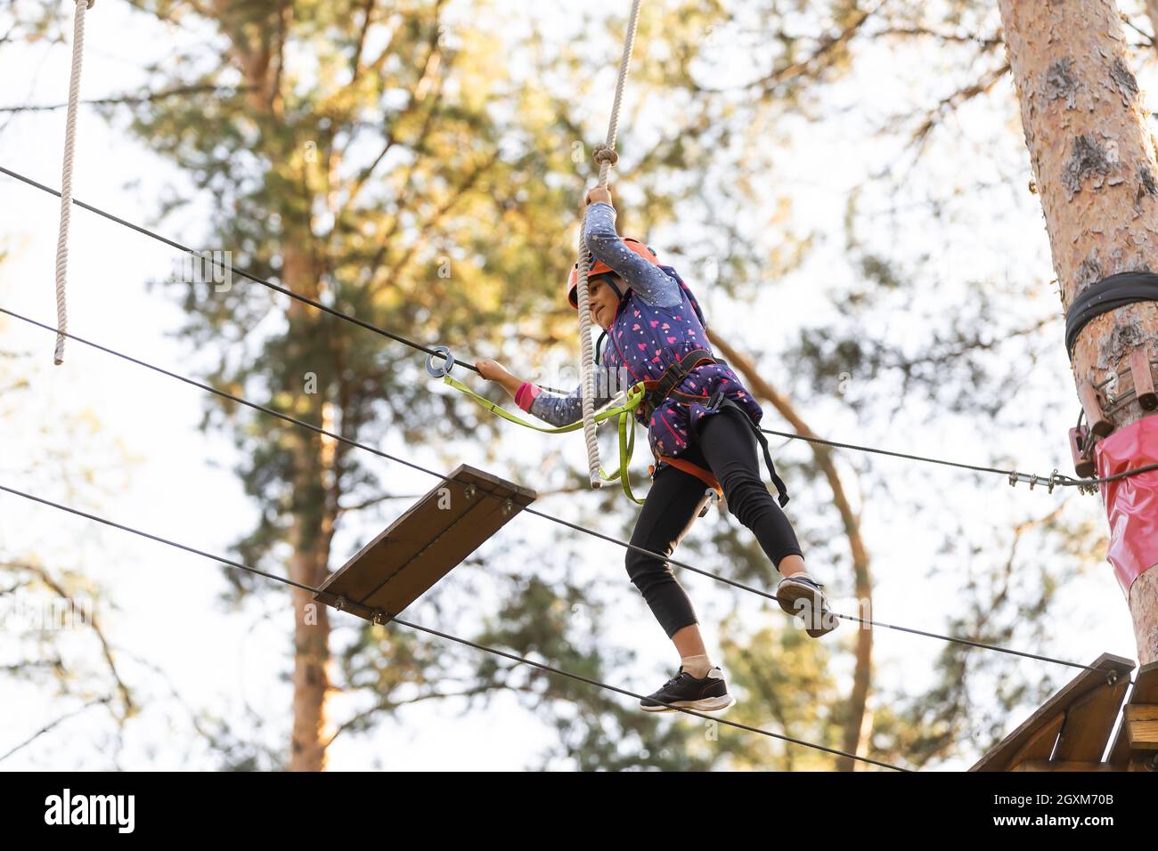 adventure climbing high wire park - people on course in mountain helmet and  safety equipment Stock Photo - Alamy