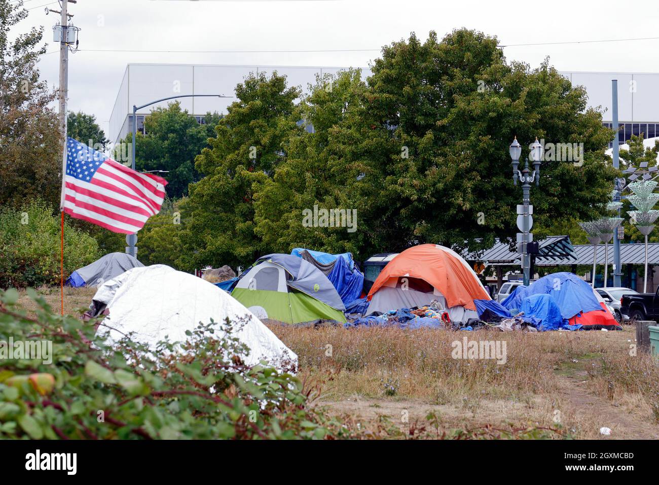 An American flag flies over a houseless, homeless encampment in the Rose Quarter entertainment district of Portland, Oregon. September 2021 Stock Photo