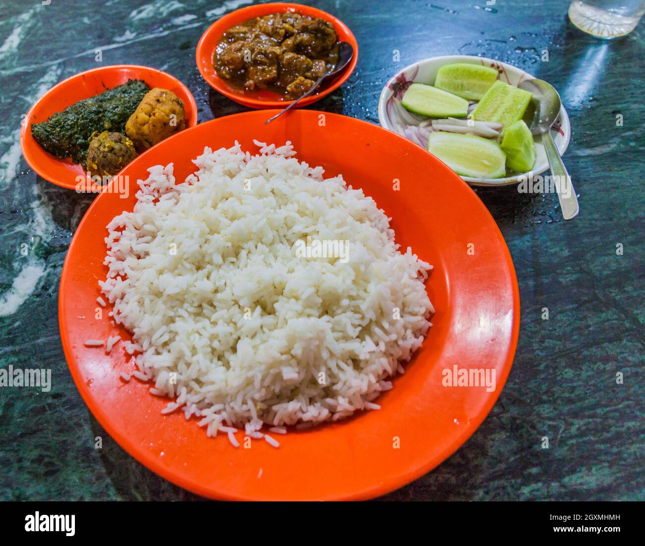 Meal in Bangladesh - Rice, Alo vorta, Shim borta and chicken curry Stock Photo