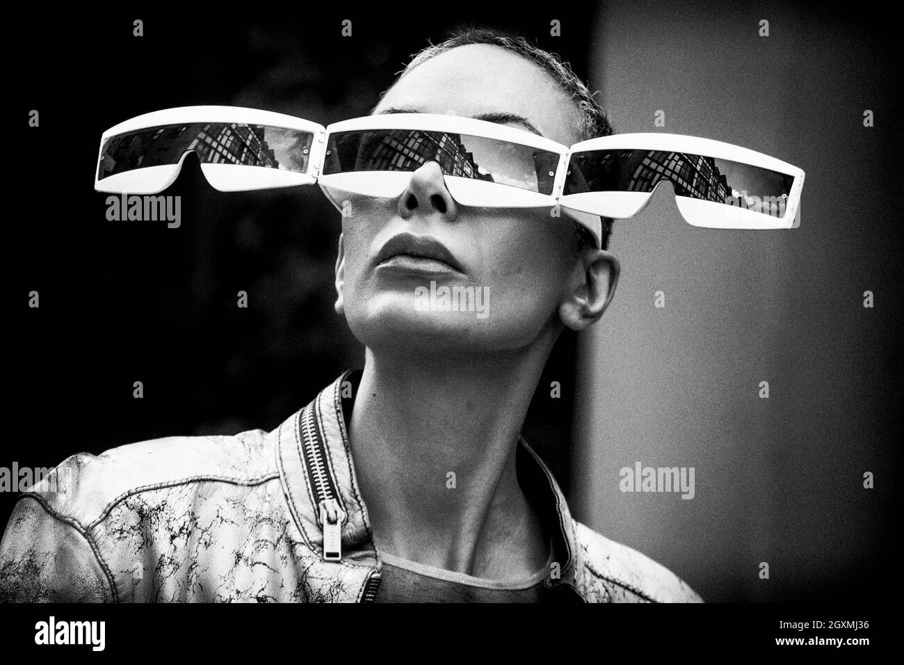 London black and white street photography: Woman with elaborate eyewear on anti-fashion demo. Stock Photo