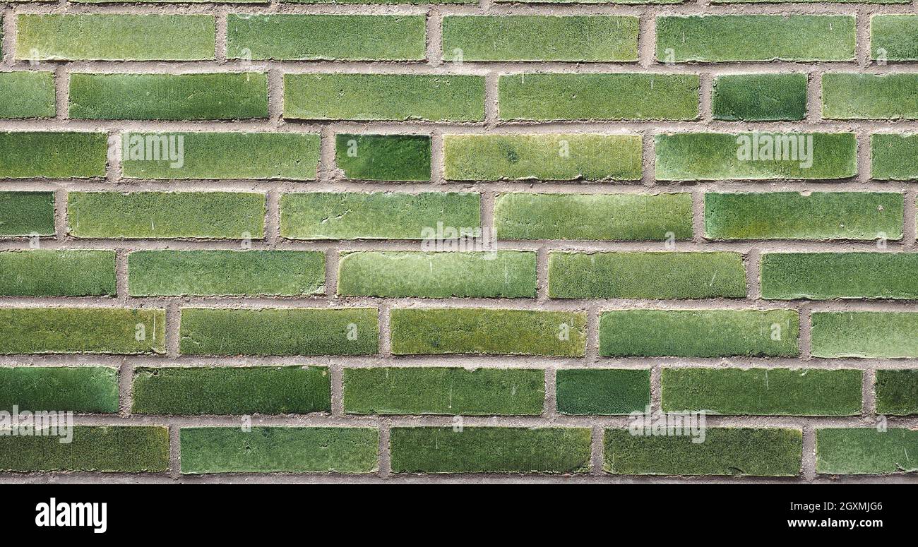 wide 4K green brick wall useful as a background Stock Photo - Alamy
