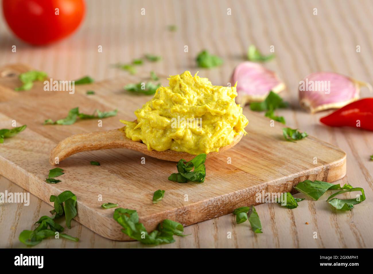 Chicken with curry spread in a pastry spoon with herbs Stock Photo