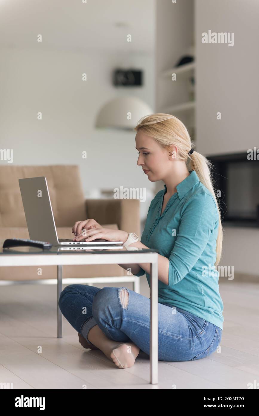 beautiful young women using laptop computer on the floor of her luxury