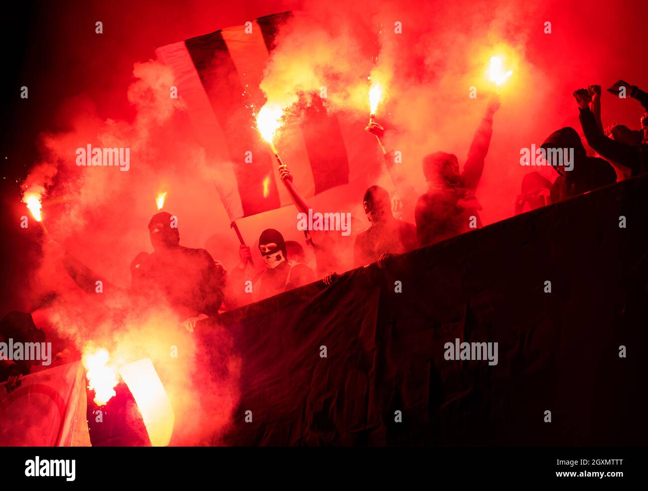 Football Hooligans With Mask Holding Torches In Fire While Supporting