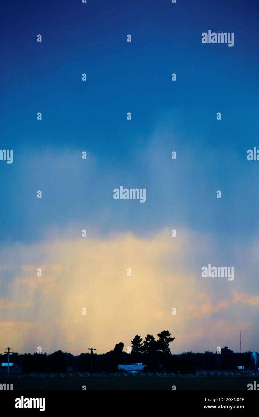 Rain coming down on farmland Stock Photo