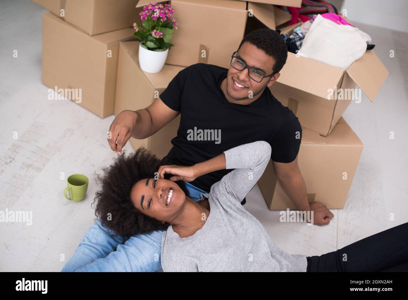 Relaxing in new house. Cheerful young African American couple sitting ...
