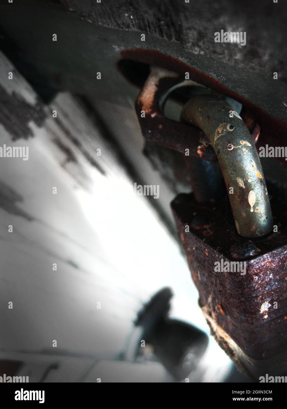 Close-up shot of a rusty lock attached to an iron door Stock Photo