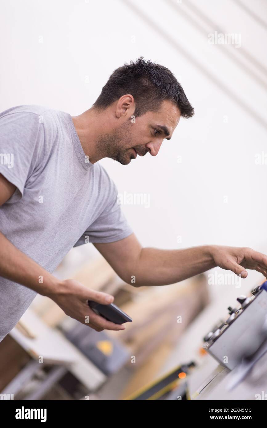 young positive engineer in front of furniture manufacture production at