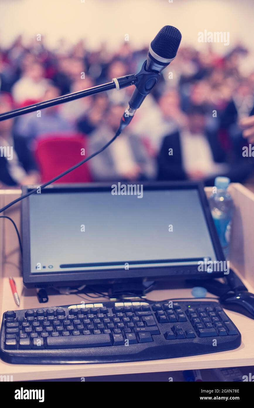laptop computer and microphone at podium on business seminar education ...