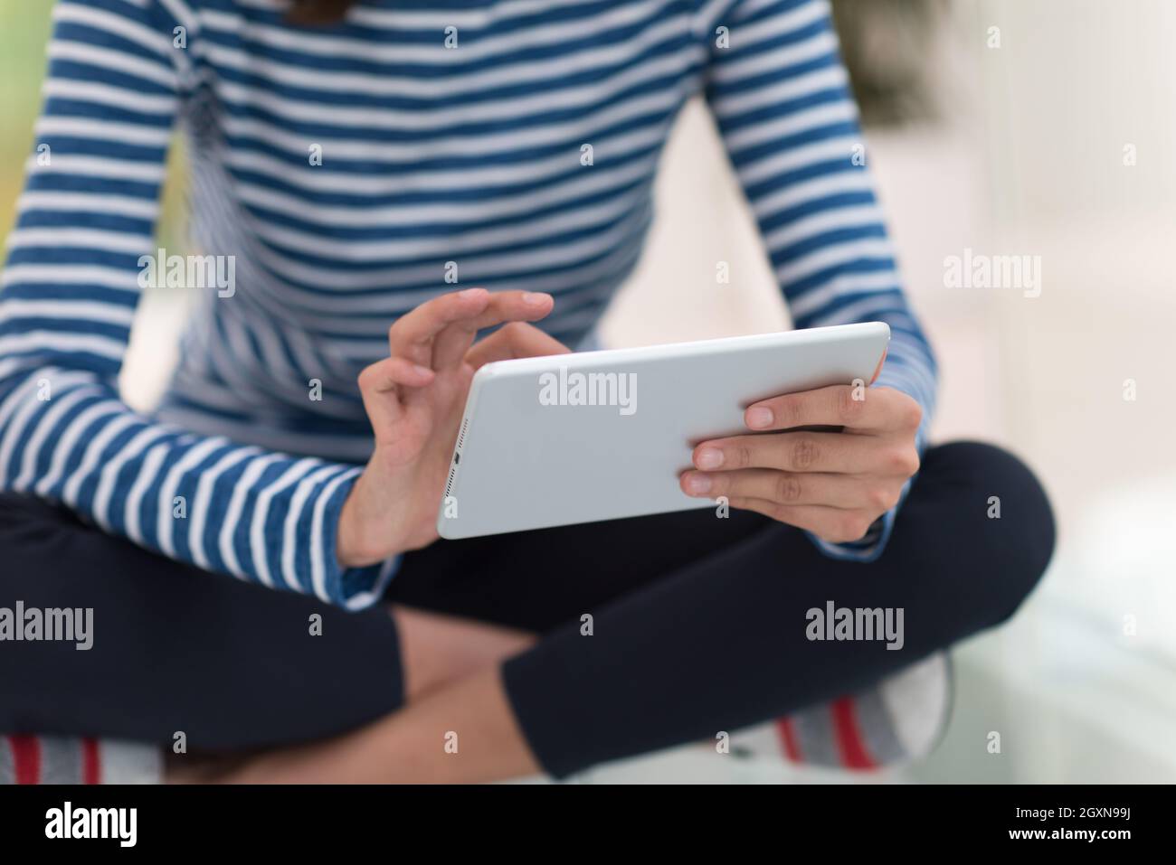 beautiful young women using tablet computer on the floor at home Stock ...
