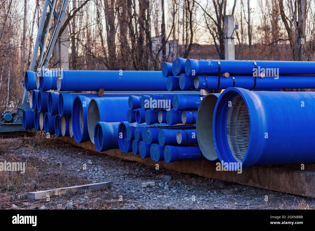 Stack of cast iron pipes in loading area waiting for transportation