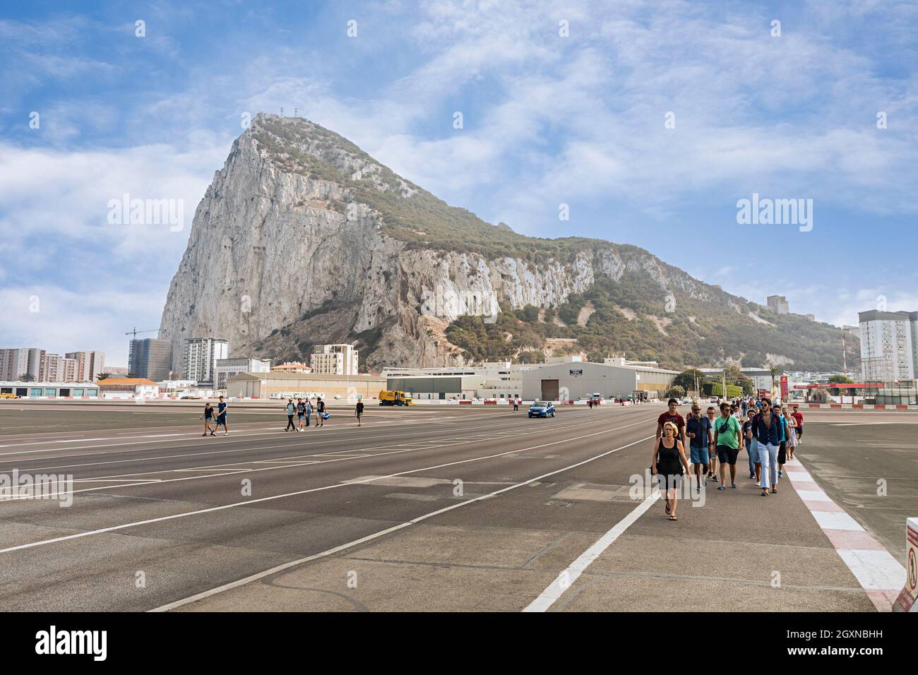 People walking across the runway to cross between Gibraltar and Spain Stock Photo