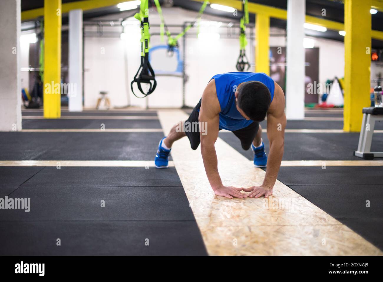 Young strong man doing pushups at cross fitness gym Stock Photo - Alamy