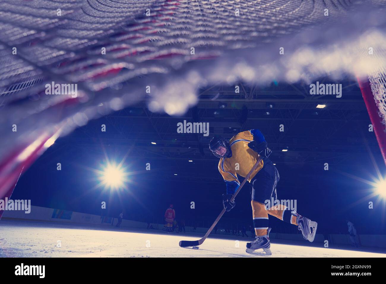 teen girl children ice hockey player in action kicking puck with stick