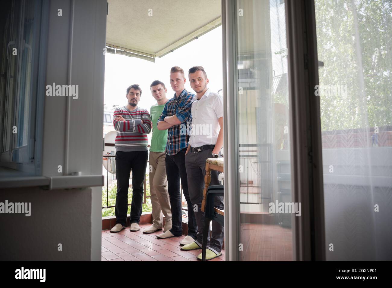 portrait of a group of men standing on the balcony Stock Photo - Alamy
